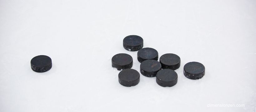 A Pile of 16 Hockey Pucks